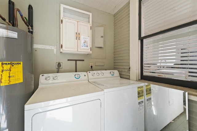 washroom with water heater, independent washer and dryer, electric panel, and laundry area
