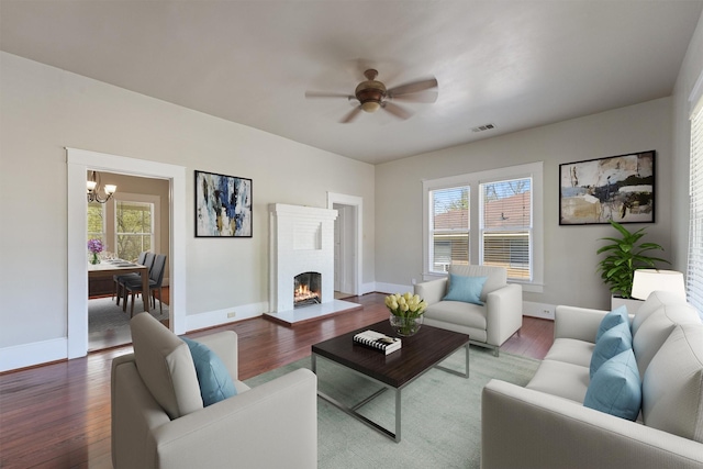 living room with visible vents, wood finished floors, and a wealth of natural light