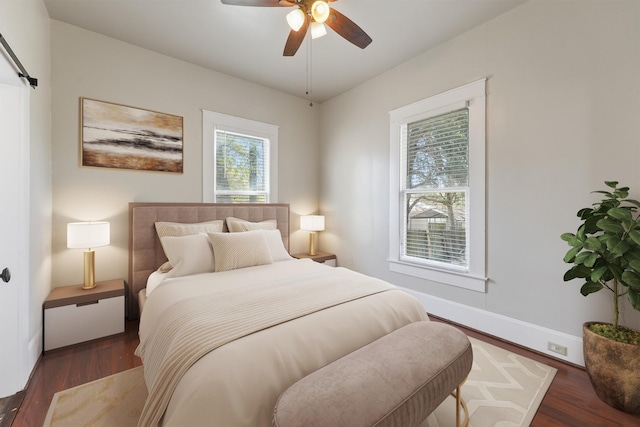bedroom featuring wood finished floors, a ceiling fan, and baseboards