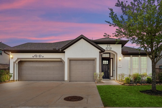 6919 Red Oak Dr, Katy, TX 77493 - view of front facade with stucco siding, an attached garage, concrete driveway, and a lawn