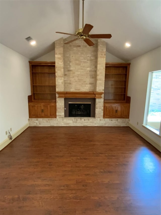 unfurnished living room featuring vaulted ceiling, visible vents, ceiling fan, a fireplace, and dark wood-type flooring