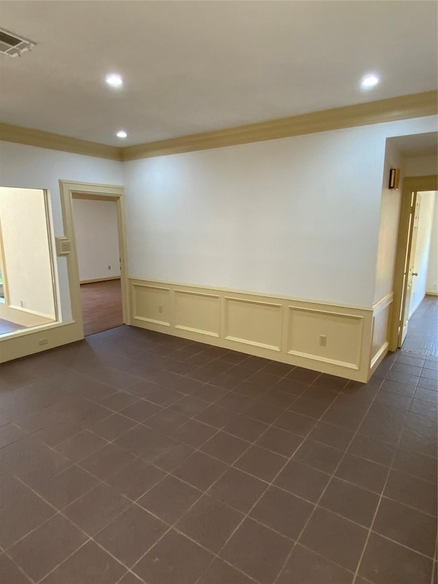 spare room with recessed lighting, ornamental molding, visible vents, and dark tile patterned flooring