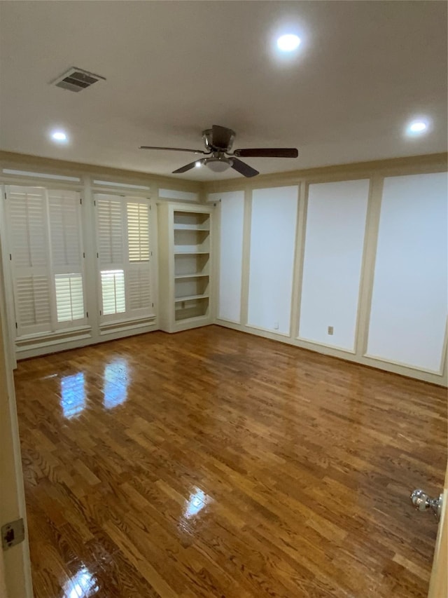 empty room with wood finished floors, visible vents, recessed lighting, and a ceiling fan