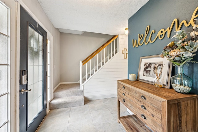 21263 Park Bluff Dr, Katy, TX 77450 - entryway with a textured ceiling, light tile patterned floors, and stairway