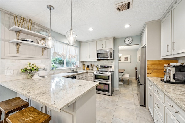 21263 Park Bluff Dr, Katy, TX 77450 - kitchen featuring decorative backsplash, visible vents, appliances with stainless steel finishes, a sink, and a peninsula