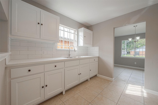 8714 Valley Flag Dr, Houston, TX 77078 - kitchen featuring a sink, tasteful backsplash, plenty of natural light, and a chandelier