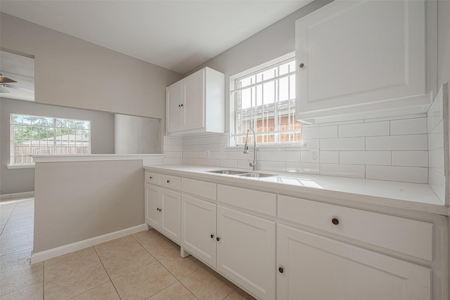 8714 Valley Flag Dr, Houston, TX 77078 - kitchen featuring tasteful backsplash, a sink, a peninsula, and white cabinets