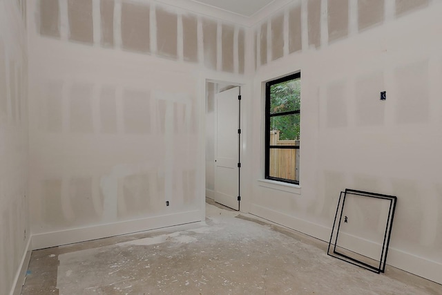 spare room with baseboards