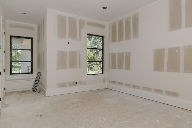 spare room featuring baseboards