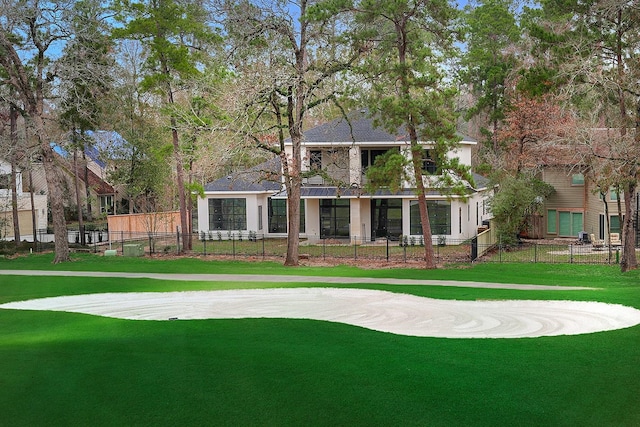 view of home's community featuring a lawn and a fenced front yard