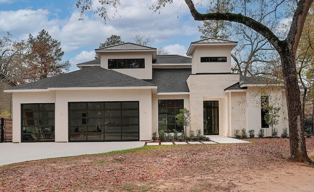view of front of property featuring an attached garage, driveway, and stucco siding