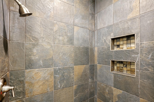 interior details with a tile shower