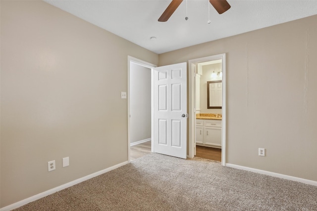 unfurnished bedroom with ensuite bathroom, baseboards, ceiling fan, and light colored carpet