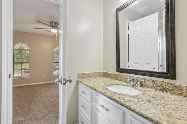 bathroom featuring vanity, baseboards, and a ceiling fan