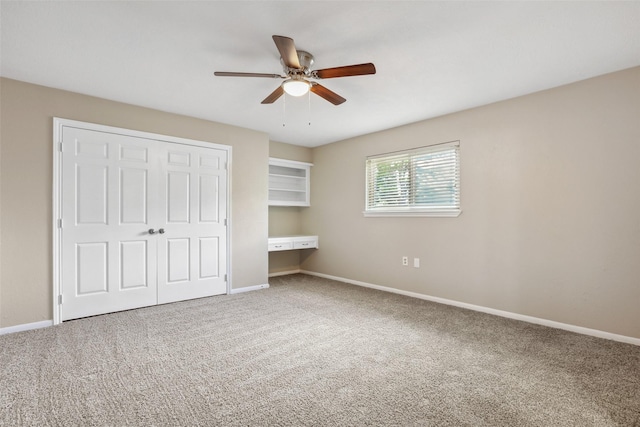 unfurnished bedroom featuring carpet floors, baseboards, and a closet
