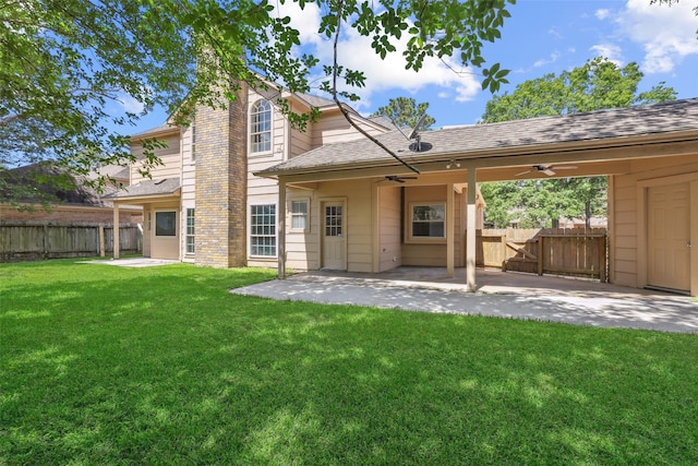 back of property featuring a ceiling fan, a patio area, a yard, fence, and a shingled roof