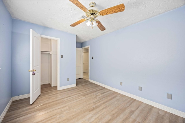 unfurnished bedroom featuring a closet, baseboards, and light wood-type flooring