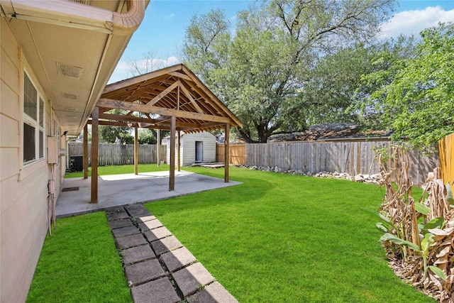 view of yard with an outdoor structure, a shed, a patio area, central AC unit, and a fenced backyard