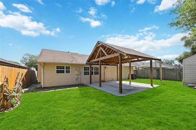 back of property featuring a patio, a gazebo, a fenced backyard, and a lawn