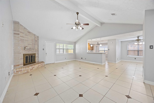 unfurnished living room with ceiling fan, a fireplace, vaulted ceiling with beams, and light tile patterned floors