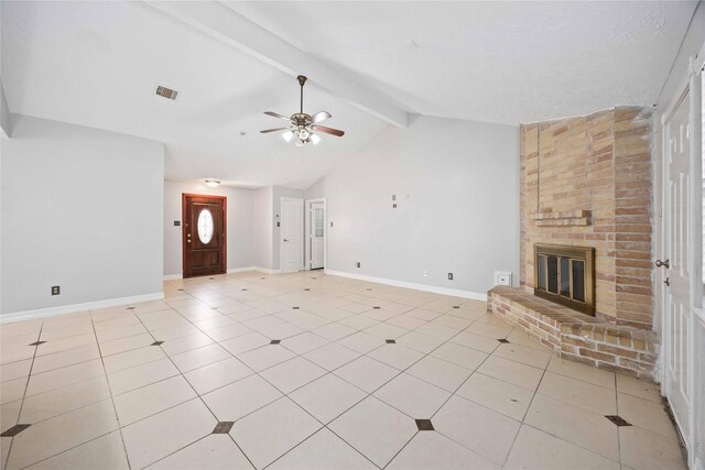 unfurnished living room with light tile patterned floors, baseboards, a brick fireplace, lofted ceiling with beams, and a ceiling fan