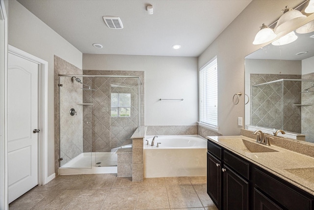 full bathroom featuring a garden tub, a stall shower, visible vents, and plenty of natural light