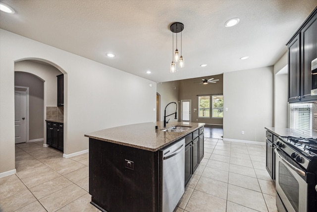 kitchen featuring light tile patterned flooring, a ceiling fan, stainless steel appliances, and a sink