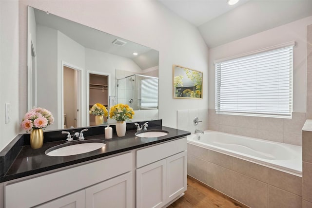 full bath featuring a sink, visible vents, a shower stall, and vaulted ceiling