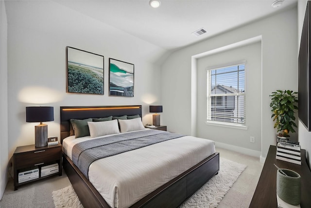 bedroom with carpet flooring, baseboards, vaulted ceiling, and visible vents