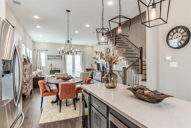 dining room featuring dark wood-style floors, recessed lighting, stairway, beverage cooler, and a chandelier