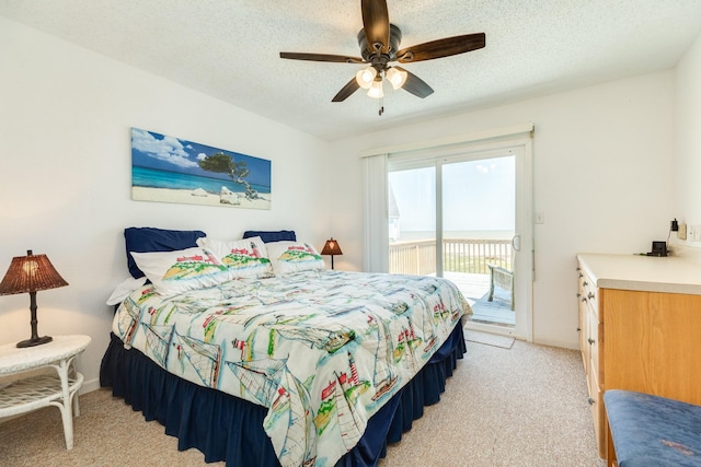 bedroom featuring light carpet, access to exterior, baseboards, and a textured ceiling