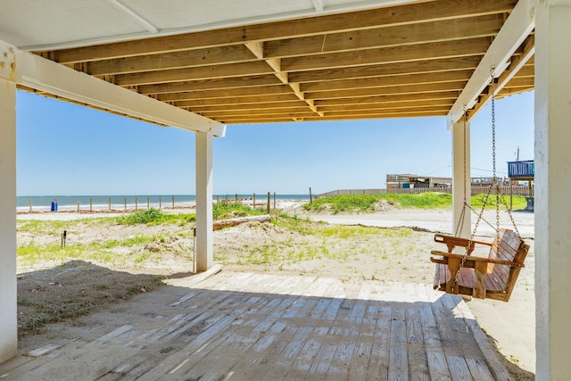 view of patio / terrace featuring view of water and beach