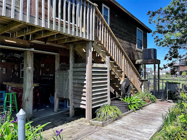 16634 Francis Drake Rd, Jamaica Beach, TX 77554 - view of exterior entry featuring central AC unit, fence, and a deck