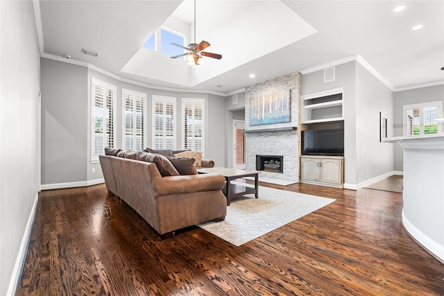 living room featuring a stone fireplace, wood finished floors, ceiling fan, baseboards, and recessed lighting