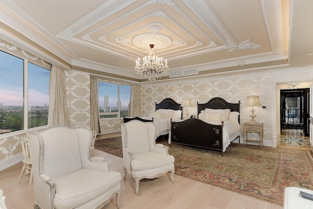 101 Westcott St Unit 2001, Houston, TX 77007 - bedroom featuring a tray ceiling, a chandelier, wood finished floors, and wallpapered walls