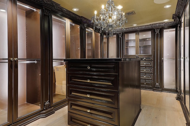 101 Westcott St Unit 2001, Houston, TX 77007 - walk in closet with a notable chandelier and light wood-style floors