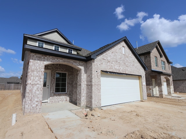 8042 Kay Harbor Dr, Cypress, TX 77433 - view of front of home featuring brick siding, an attached garage, and driveway