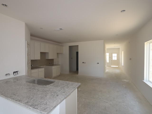8042 Kay Harbor Dr, Cypress, TX 77433 - kitchen featuring white cabinets, a peninsula, and light stone counters