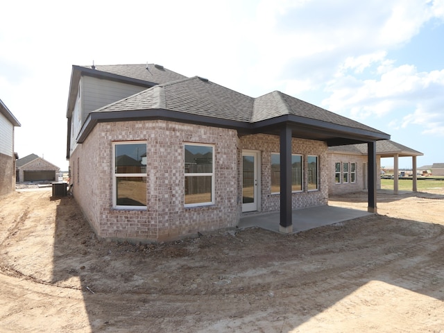 8042 Kay Harbor Dr, Cypress, TX 77433 - back of house featuring a patio, brick siding, and a shingled roof