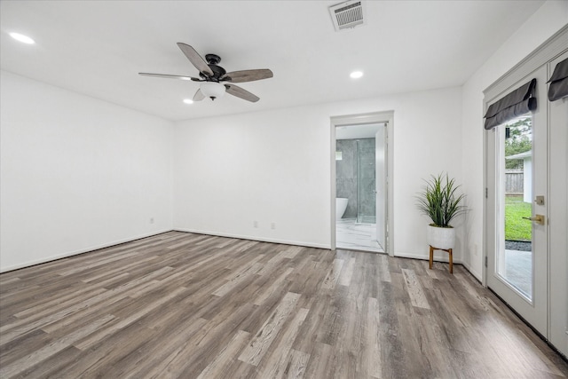 empty room with recessed lighting, wood finished floors, ceiling fan, baseboards, and visible vents
