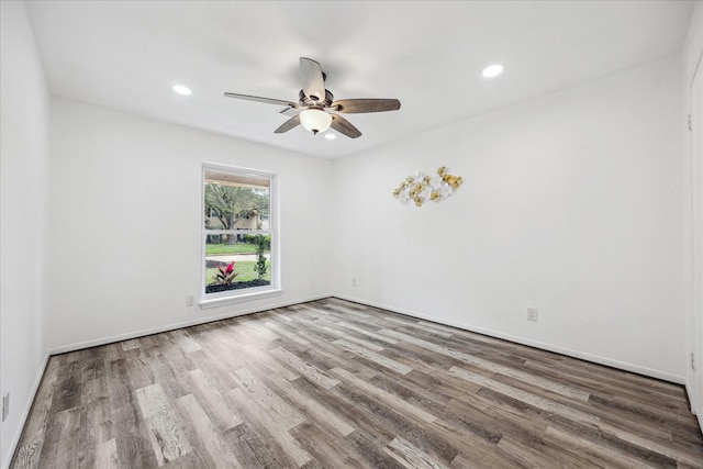 spare room featuring wood finished floors, ceiling fan, recessed lighting, and baseboards