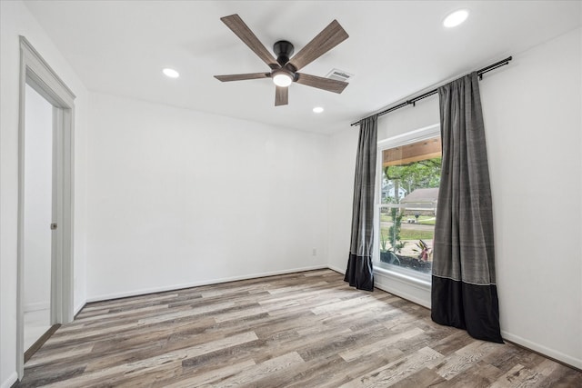 unfurnished room with recessed lighting, ceiling fan, wood finished floors, and visible vents