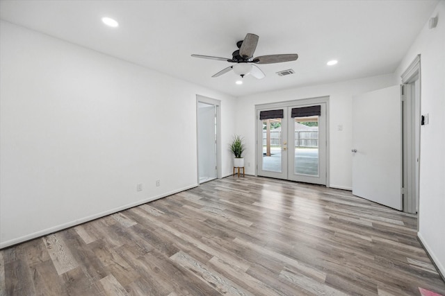 spare room featuring wood finished floors, visible vents, french doors, and recessed lighting