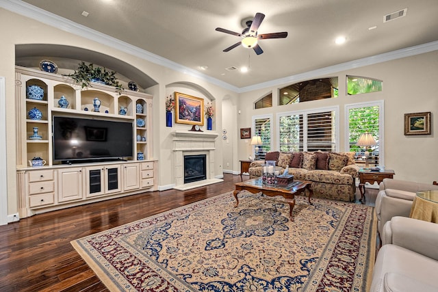 2469 S Bramlet Dr, Conroe, TX 77304 - living area featuring dark wood-style floors, ornamental molding, ceiling fan, a glass covered fireplace, and recessed lighting