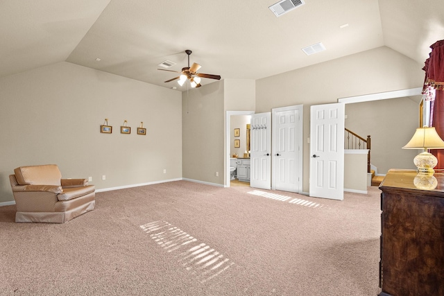 living area featuring visible vents, vaulted ceiling, and light carpet