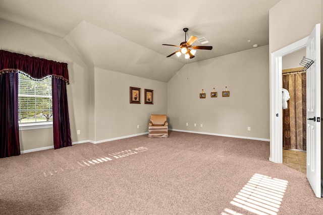 unfurnished bedroom featuring baseboards, carpet, ceiling fan, and vaulted ceiling