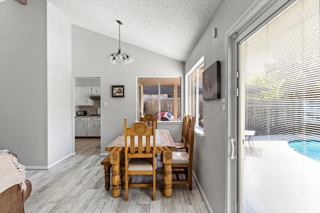 15707 Spring Forest Dr, Houston, TX 77059 - dining room with lofted ceiling, a chandelier, light wood-type flooring, a textured ceiling, and baseboards