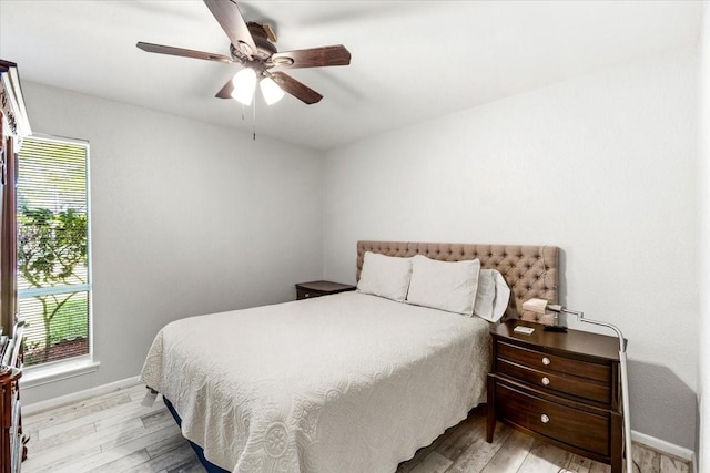 15707 Spring Forest Dr, Houston, TX 77059 - bedroom featuring light wood-style flooring, baseboards, and a ceiling fan