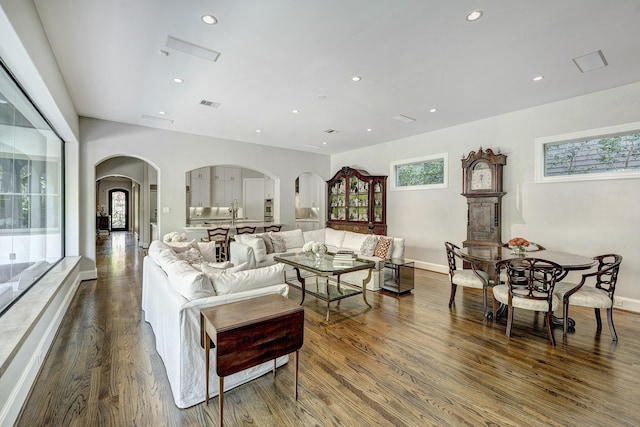609 Reinicke St, Houston, TX 77007 - living room with arched walkways, wood finished floors, visible vents, and recessed lighting