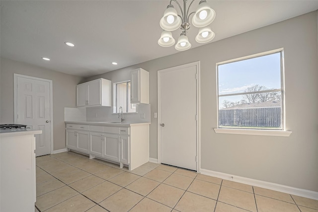 8719 Valley Meadow Dr, Houston, TX 77078 - kitchen with white cabinets, light tile patterned floors, and light countertops